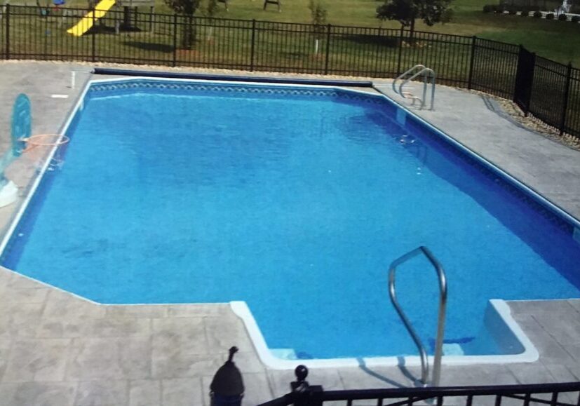 GRECIAN A pool with stairs and a fence around it