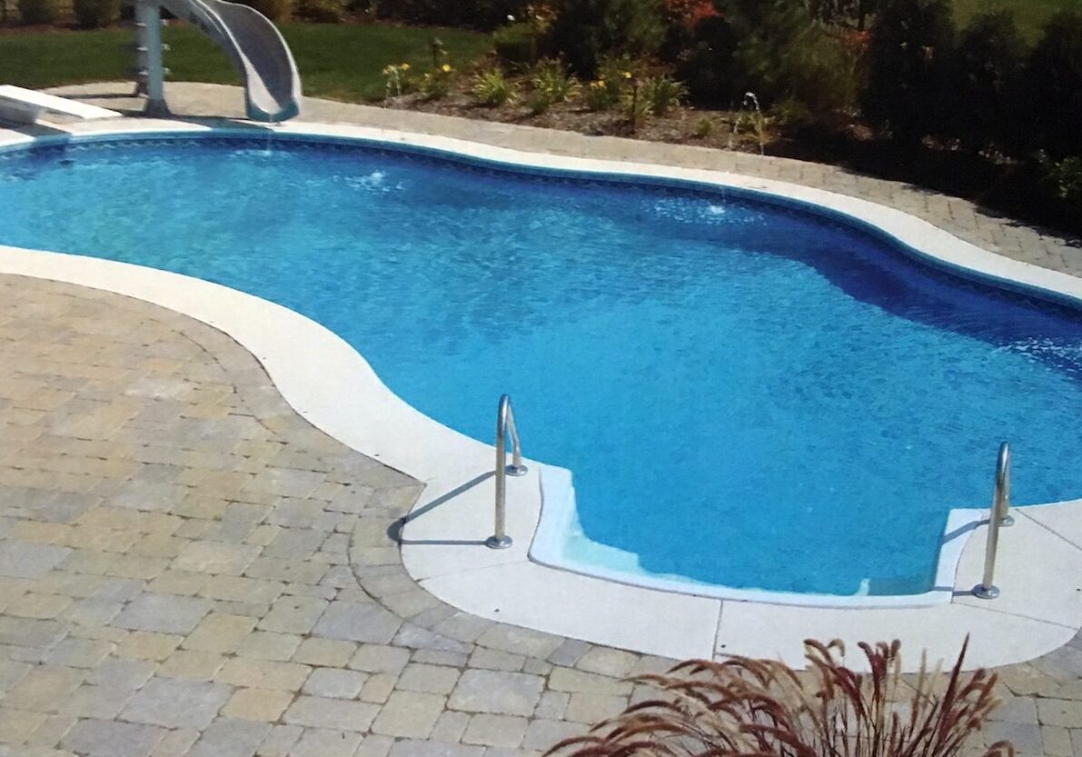 TRADEWINDS A pool with an enclosure and slide in it